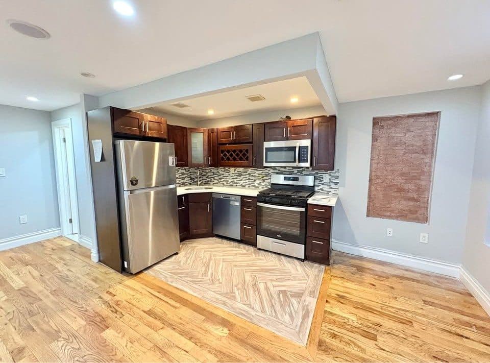 Kitchen with dark wood cabinets and herringbone floors