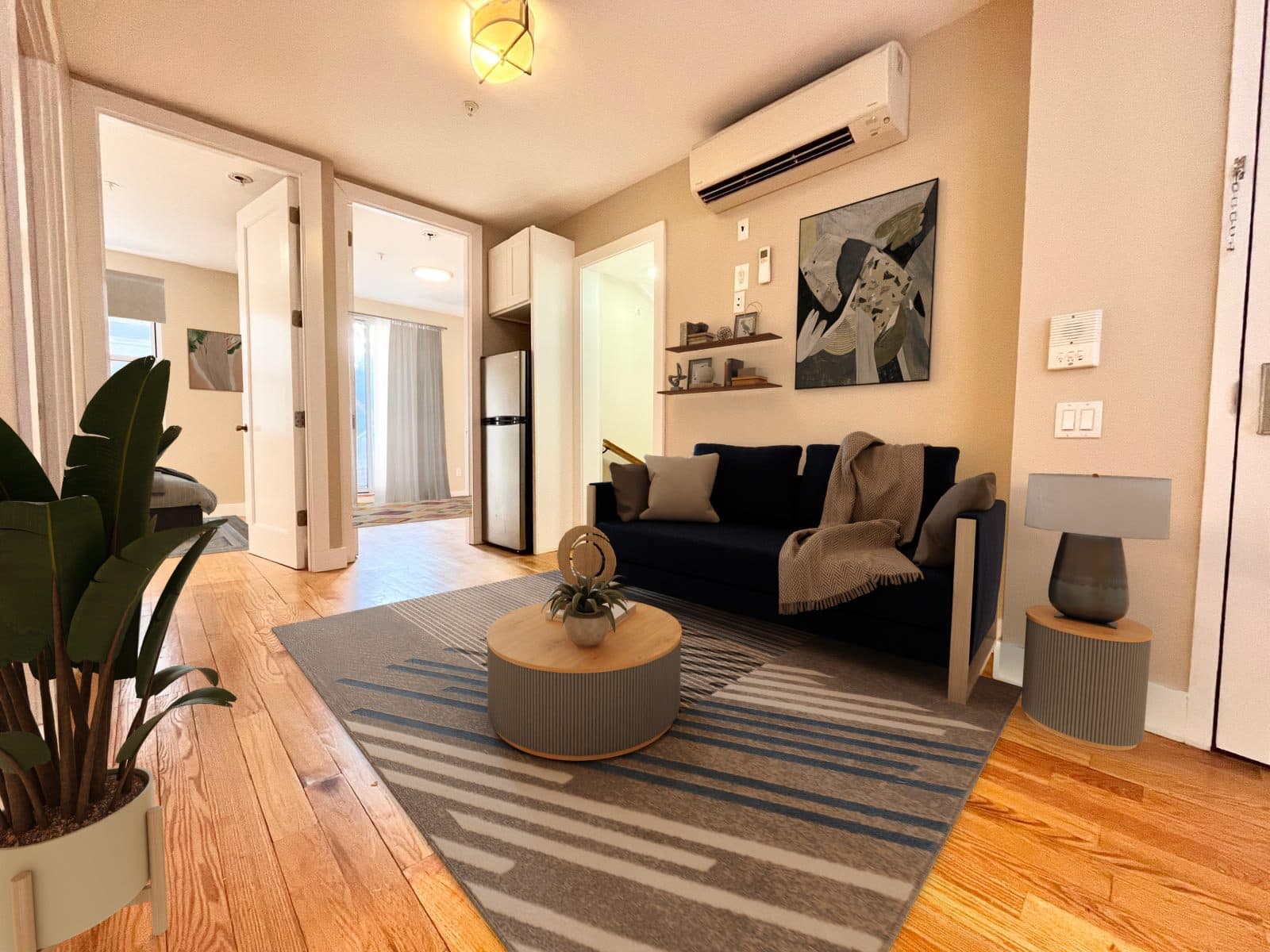Living room with hardwood floors and an open layout, virtually staged