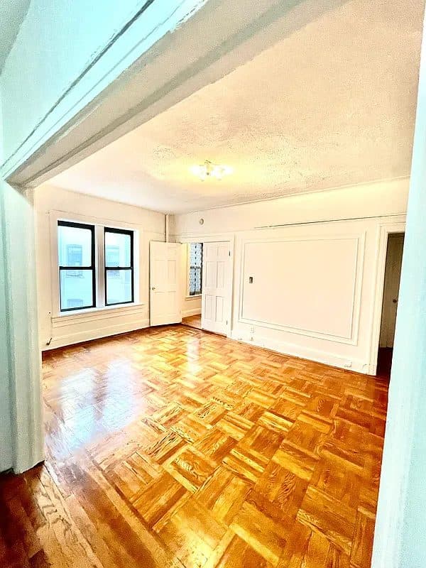 Empty prewar room with parquet floors